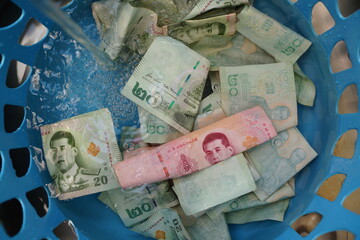 Thai banknotes during the COVID-19 outbreak need to be cleaned before use. Photo taken on 26 Jan 2021.