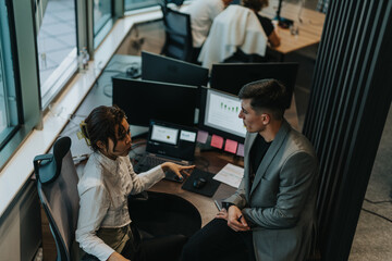 Two business people engaging in a brainstorming session in a modern office. The image highlights teamwork, creativity, and innovative thinking among diverse and multigenerational colleagues.