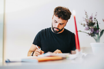 A college student intensely studying at home, surrounded by books and notes. Soft candlelight and flowers create a calm and focused atmosphere, enhancing concentration and learning.