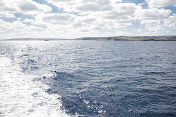 Seascape of Mediterranean sea near Malta made from moving yacht on sunny day