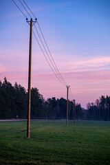electric pylons in countryside. Electricity line in agricultural field