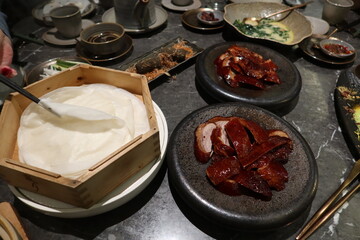 close up of Chinese pancake slice  in round white in a bamboo steamer for wrapping Beijing Peking...