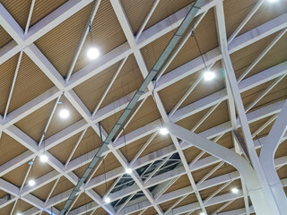 Modern Geometric Ceiling Design with White Framework and Triangular Patterns