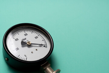 close up of pressure gauge on green table background, engineering equipment concept.