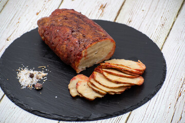 Washed flour seitan, vegan glazed ham sliced on black slate stone