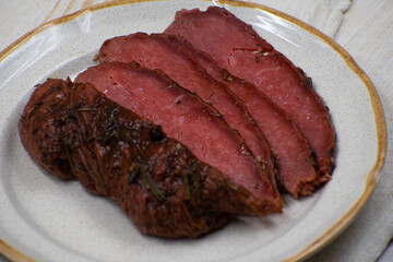 Vegan steak made with gluten and spices, sliced on ceramic plate