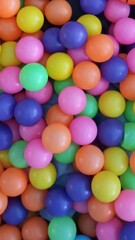 colorful plastic balls on children's playground. 
Colorful plastic balls, create a cheerful atmosphere, suitable for children's play area or party decoration.vertical format