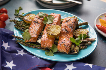 Grilled Salmon with asparagus, zhuccini on blue plate. Celebrating Independence Day, July 4.