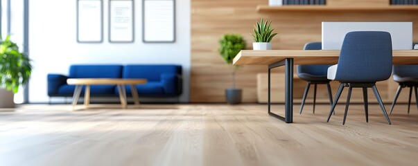 A modern, minimalist office space featuring a wooden floor, a blue couch, and a large desk with chairs, complemented by decorative plants.