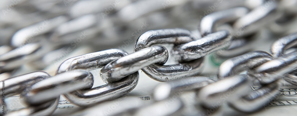 Poster a close-up view of metallic chain links, showcasing their interlocking design and reflective surface