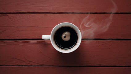 cup of black coffee on a red wood background top view