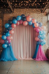A dance floor with numerous balloons arranged in the shape of an arch. In front of it, a curtain made from pink and blue tulle. 