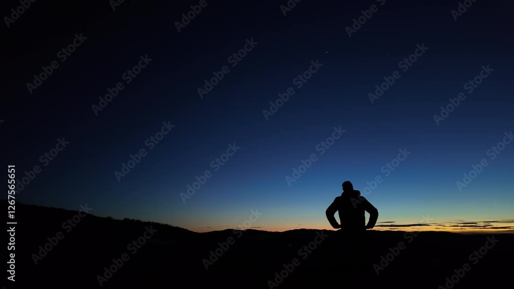 Wall mural silhouette of a man observing milky way stars, planets and other celestial objects from a dark count