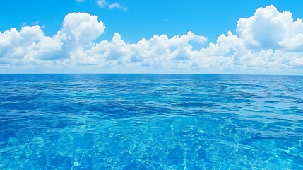 Fototapeta premium Crystal Clear Ocean View Under a Bright Blue Sky with White Clouds at the Horizon Line