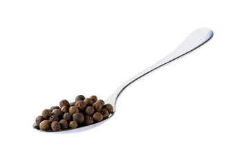allspice or Jamaican pepper in a metal spoon isolated on white background.
