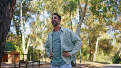 Proud father looking distance standing summer park closeup. Man waving hand