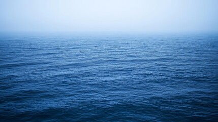 Obraz premium Serene Ocean Under a Misty Sky