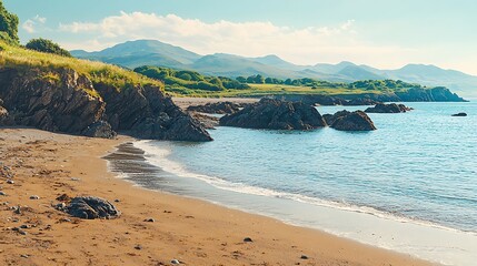 Obraz premium Sandy beach, coastal rocks, mountain backdrop, calm sea, travel postcard