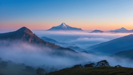 Fototapeta premium Misty Mountain Landscape at Dawn with Soft Light and Silhouetted Peaks Above Foggy Valley Under Clear Blue Sky