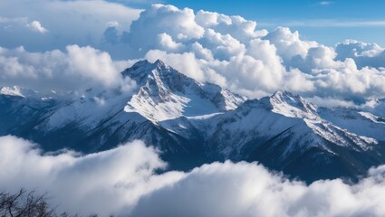 Majestic snow-covered mountain peaks rising above thick white clouds under a clear blue sky showcasing nature's breathtaking beauty.