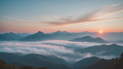 Obraz premium Serene Mountain Landscape at Sunset with Layers of Mist and Empty Sky for Text Placement