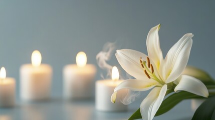 white lily and candles in remembrance