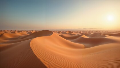 Vast desert dunes under a clear sky at sunset.