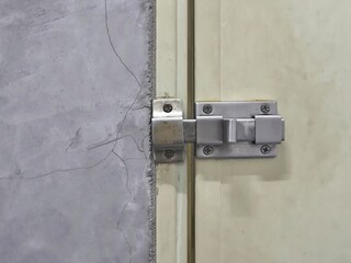 Minimal doorknob on toilet wood door. Safety concept