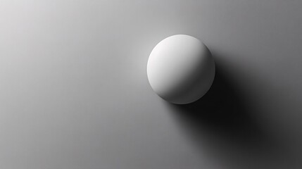A minimalistic image featuring a white sphere casting a soft shadow on a light gray surface, evoking simplicity and elegance.
