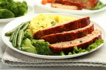 Delicious baked turkey meatloaf with mashed potato served on table, closeup