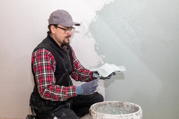 Construction Worker Plastering Wall – Renovation and Drywall Repair