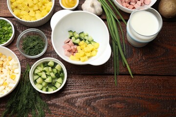 Ingredients for okroshka soup on wooden table, flat lay. Space for text
