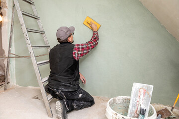 Construction Worker Plastering Wall – Renovation and Drywall Repair
