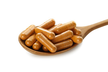 Turmeric capsules in spoon isolated on white