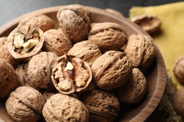 Fresh ripe walnuts in shells on table, closeup