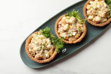 Tartlets with delicious filling on white marble table, top view
