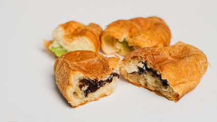 Delicious fresh croissant filled with matcha jam and chocolate filling, a European dessert