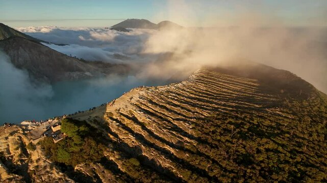 Aerial view drone orbit around to reveal Kawah Ijen volcano crater, Indonesia