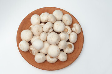 Whole Mushrooms on a Wooden Plate – Top View
