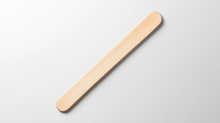 A rustic wooden spoon placed on a pristine white surface ideal for cooking or kitchen decor