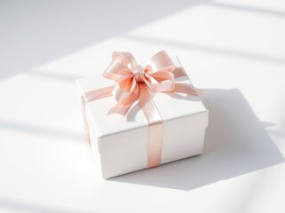 White gift box with peach ribbon bow on white background