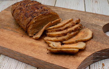 Seitan: vegan meat alternative made of washed flour gluten spices. Roasted and served on wooden board