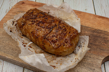 Seitan: vegan meat alternative made of washed flour gluten spices. Roasted and served on wooden board