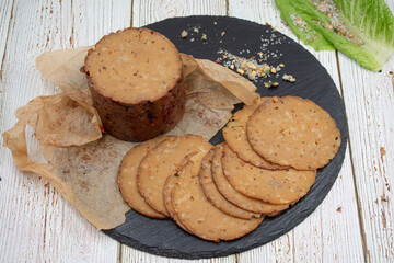 Seitan shaped and cooked in ham press, sliced on slate board. Vegan protein, plant based alternative to meat.