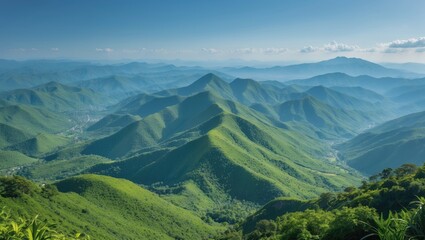 Obraz premium Lush green mountain landscape with rolling hills and valleys under a clear blue sky Copy Space