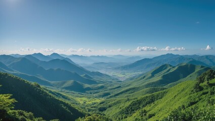 Naklejka premium Panoramic view of lush green mountains under clear blue sky with distant hills and clouds in the background Copy Space