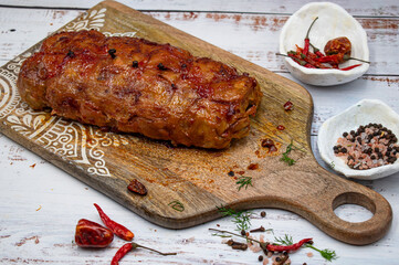 Seitan roast flavored with spices, glazed and served on wooden board
