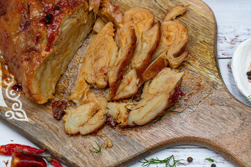 Seitan roast flavored with spices, glazed and served on wooden board