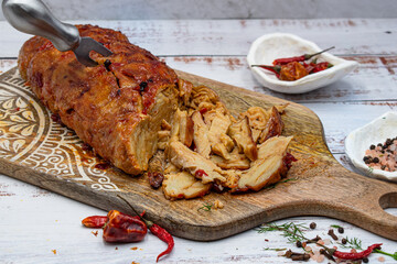 Seitan roast flavored with spices, glazed and served on wooden board