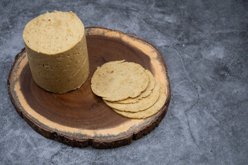 Vegan ham made in ham mold, sliced, wooden board. Mock vegan meat as plant based alternative to meat.